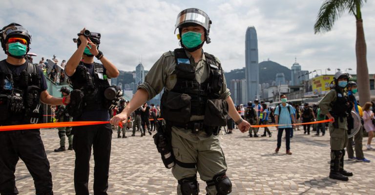 epa08413119 Police cordons off an area at the start of a pro-independence march in Hong Kong, China, 10 May 2020. A heavy police presence in Tsim Sha Tsui thwarted plans for a pro-independence march, but several ?sing with you? protests popped up at several malls across Hong Kong.  EPA-EFE/JEROME FAVRE