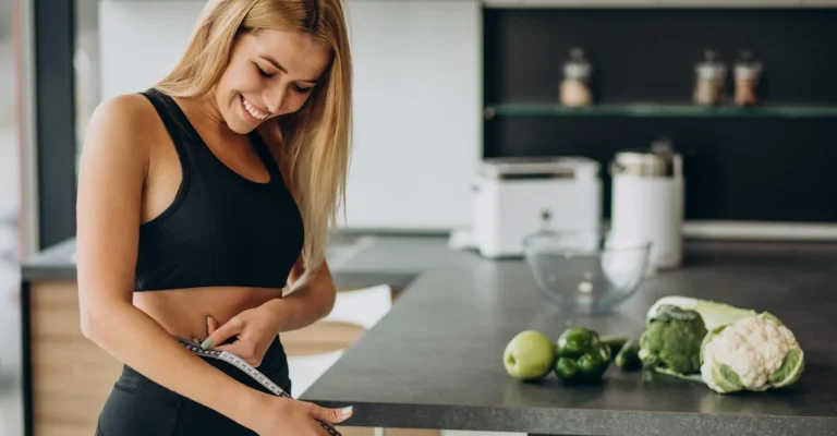 zena-dietayoung-woman-with-measuting-tape-weist-kitchen.webp.webp